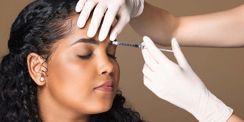 Certified injector administering Letybo to reduce forehead wrinkles naturally, at Aurspa Med Spa located in Middleburg, FL and close to Jacksonville, Eagle Landing, Oakleaf Plantation