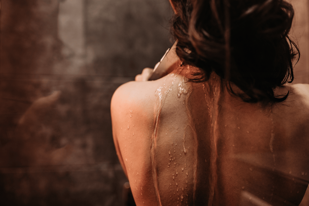 Professional esthetician performing a customized back facial to treat congestion, back acne, and dry skin while promoting a healthy, radiant complexion.