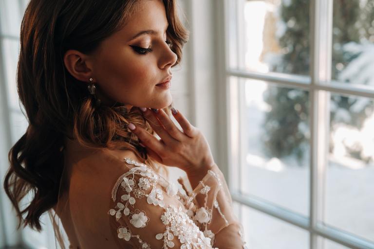 Happy bride admiring her glowing skin after professional pre-wedding spa treatments at AURSPA near Jacksonville, Florida.